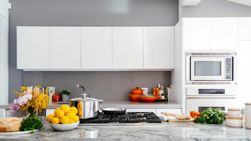 Professional cleaner wiping down a bright kitchen counter